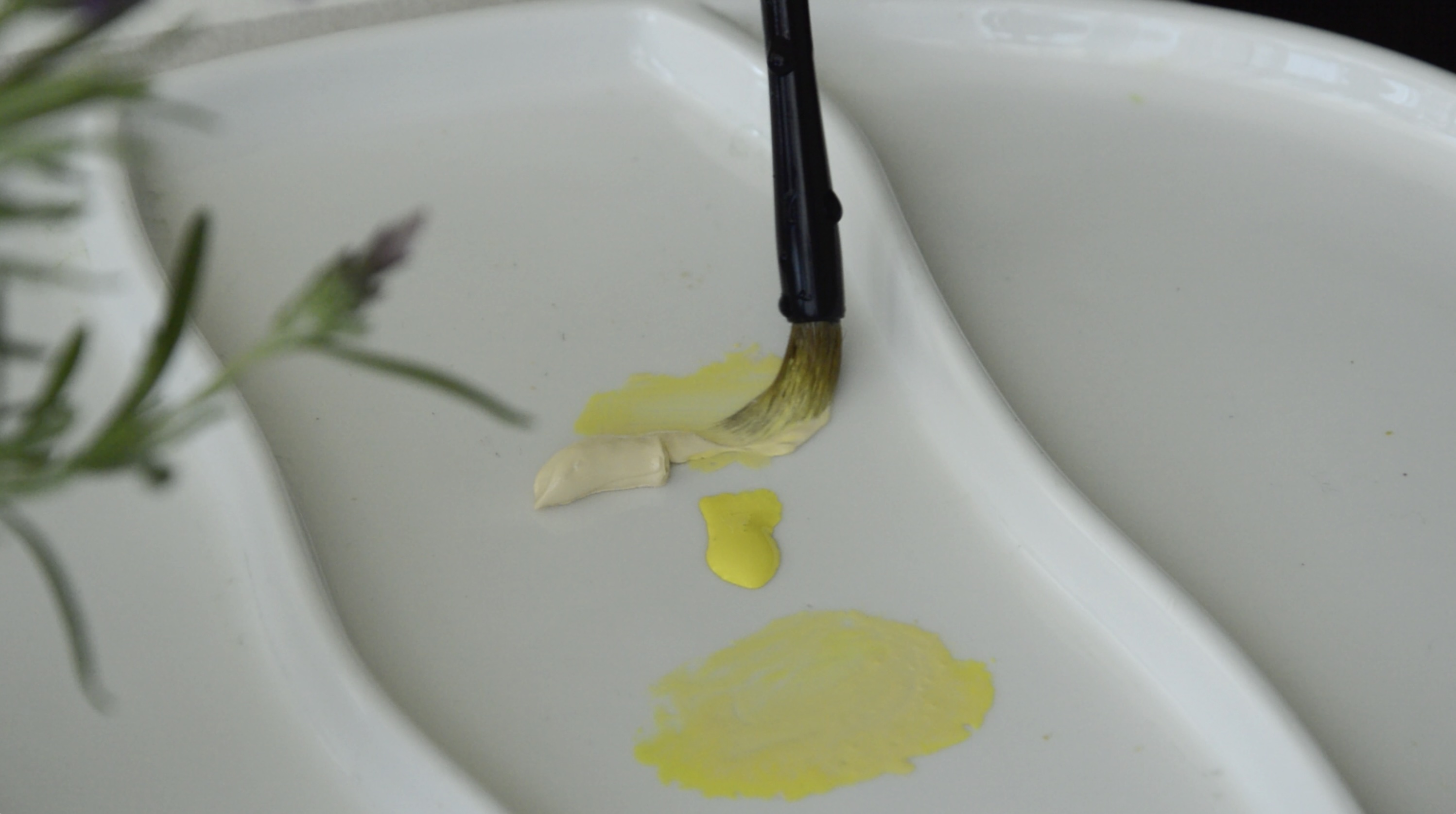 Artist holding a watercolor palette and brush